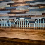 dining table top, with chairs and reclaimed wood wall